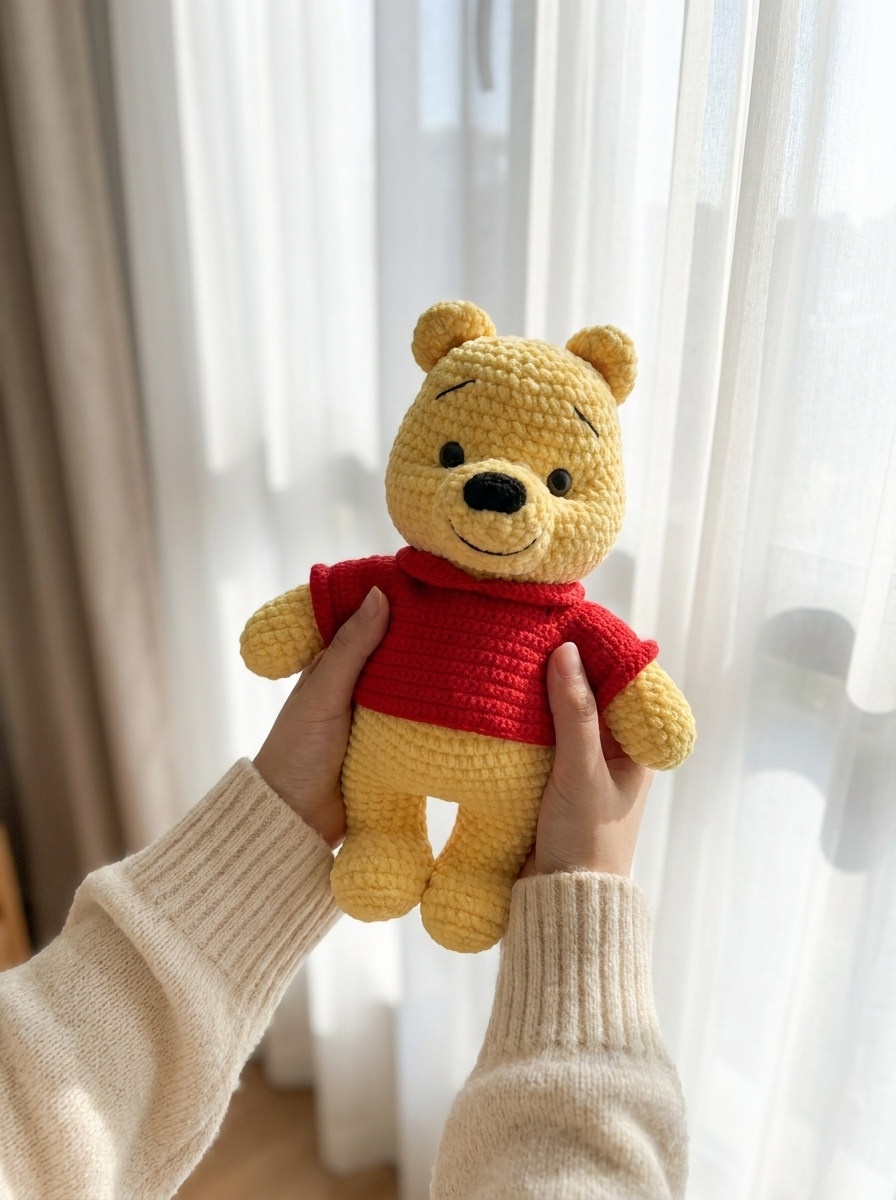 Copper Leaf Crochet Amigurumi Bear Pattern - hands holding the crochet bear by a bright window